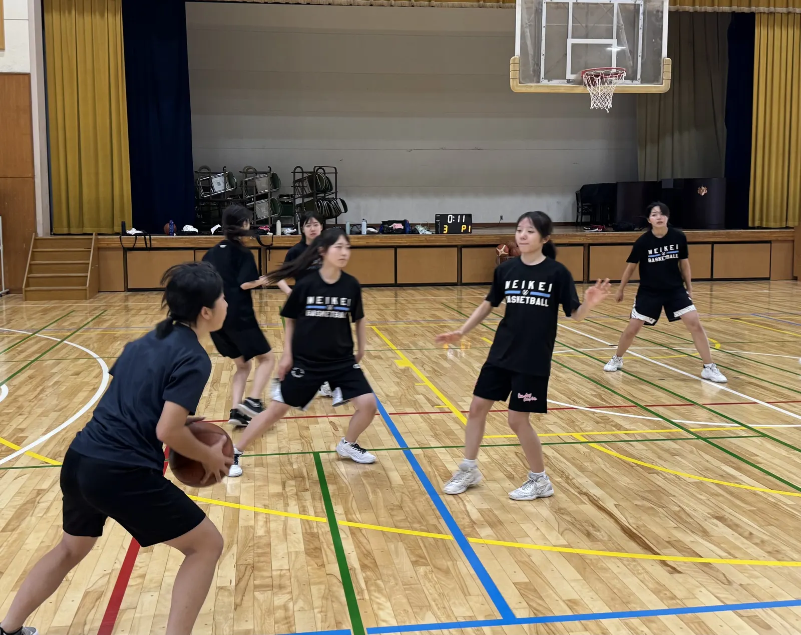 MEIKEI BASKETBALL 티셔츠를 입고 공격과 수비 연습을 하는 여학생 농구부원들